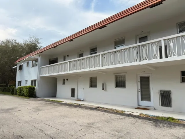 White stucco exterior with a terra cotta tile roof