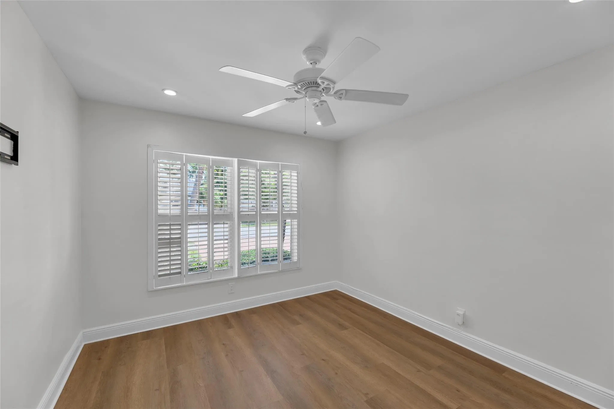 Bedroom with new flooring, plantation shutters and overhead ceiling fan