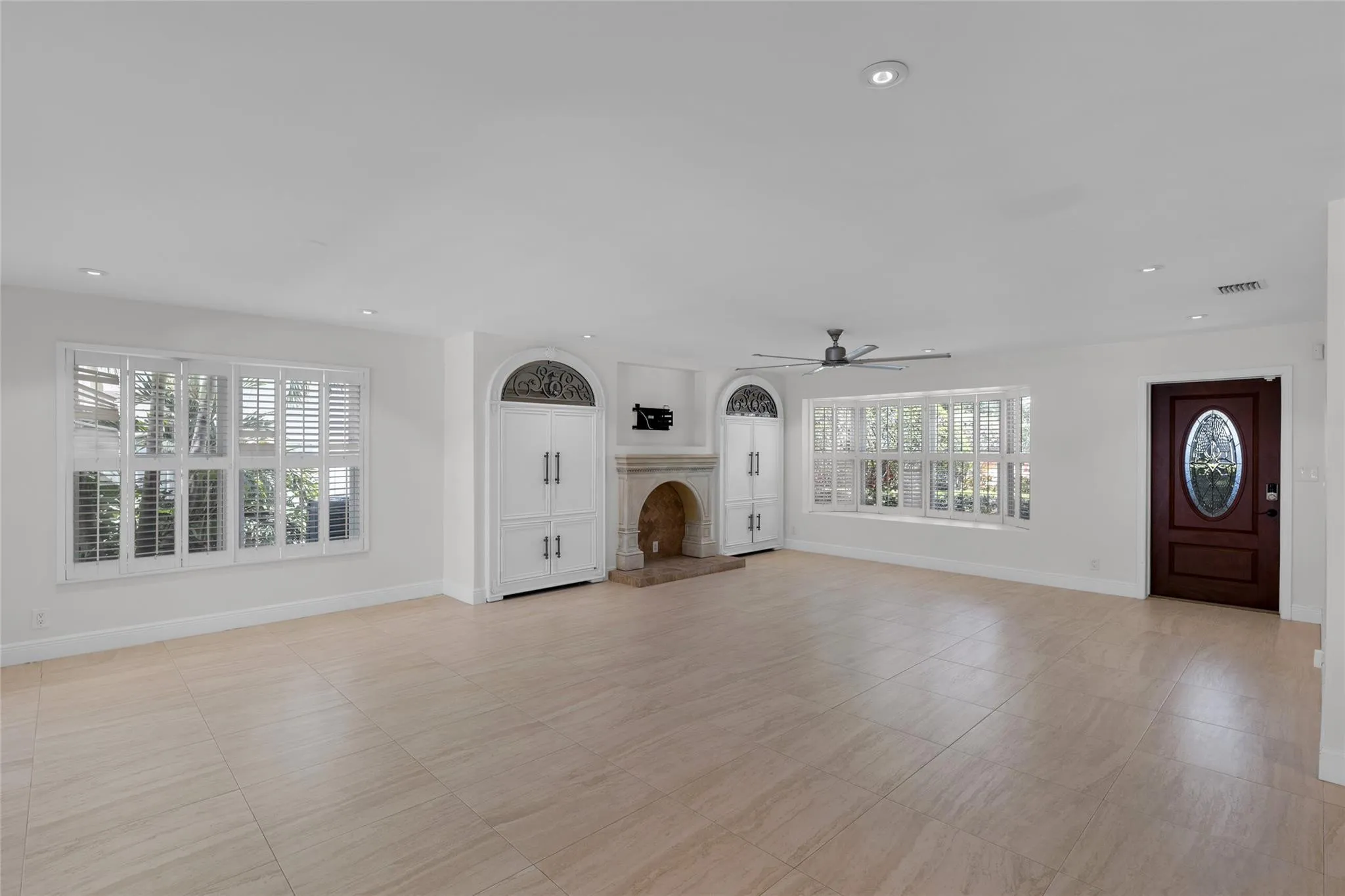 Spacious living room with bay window and plantation shutters