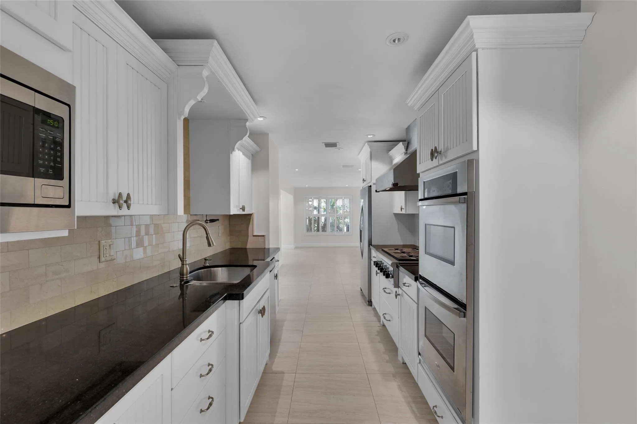 The kitchen offers gas range, double oven, granite counters, stainless appliances and tons of storage