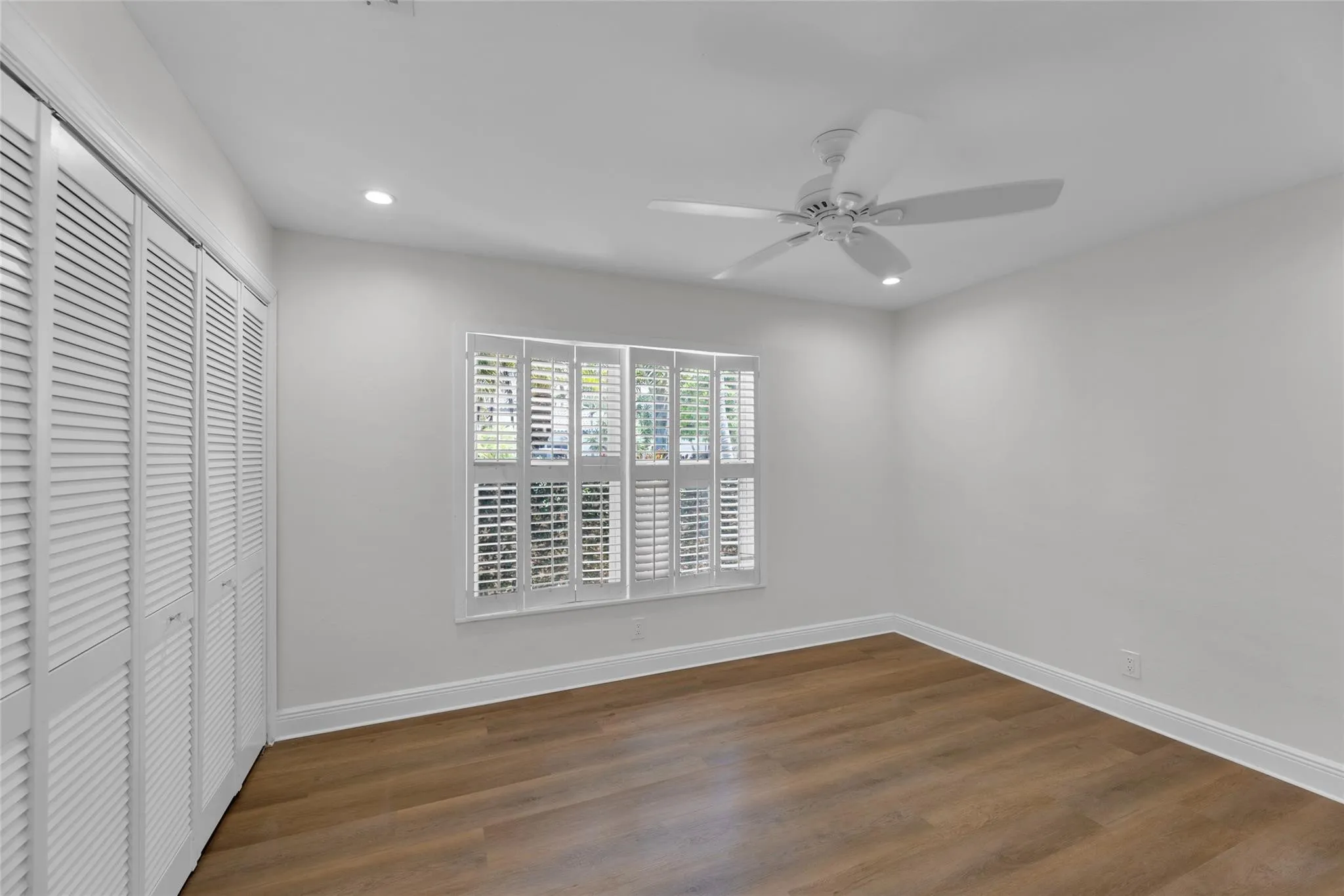 Guest bedroom offers great closet space and plantation shutters