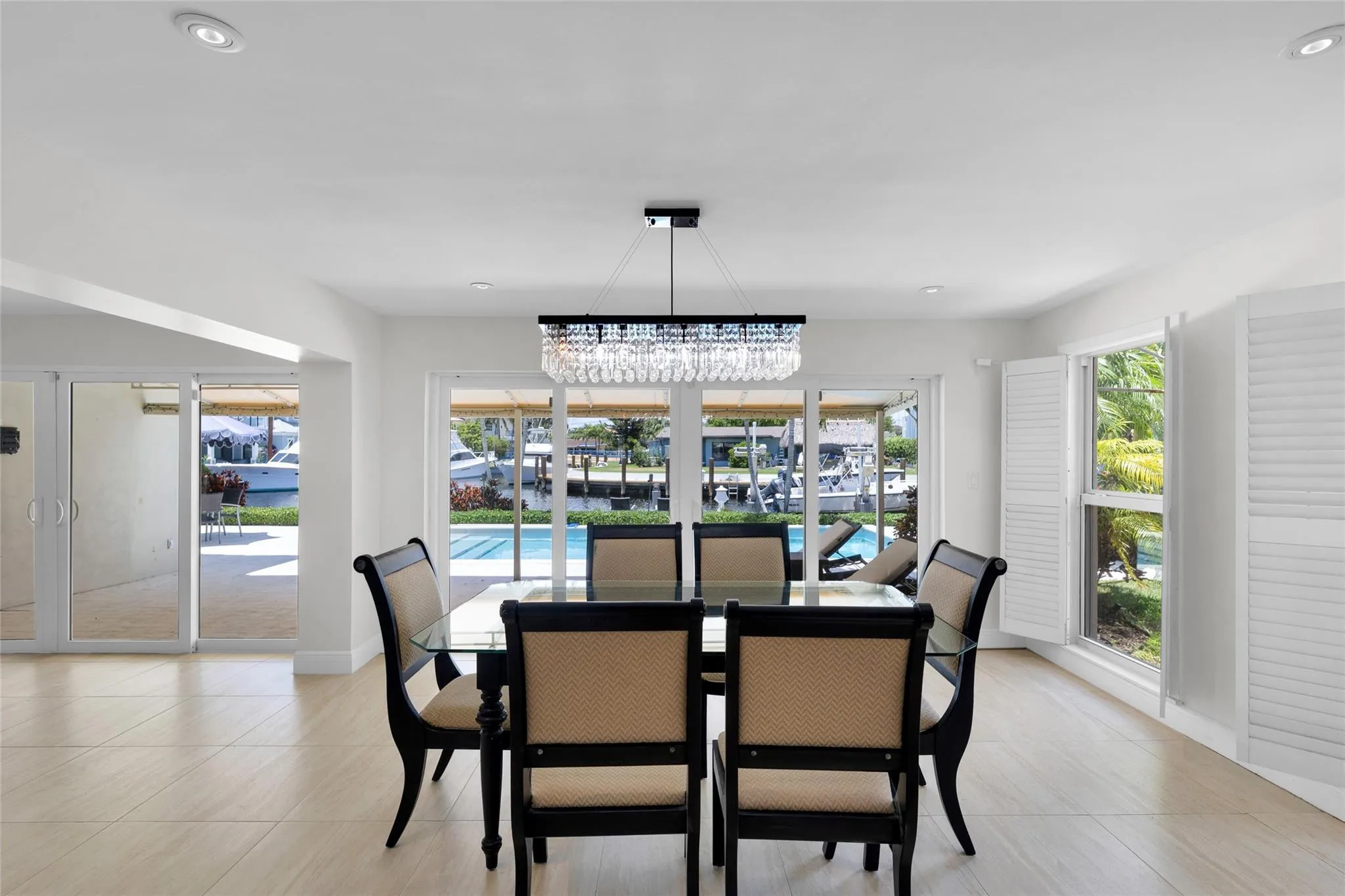 Dining room offers sliders & pool and water views