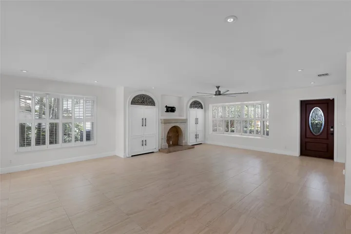 Spacious living room with bay window and plantation shutters