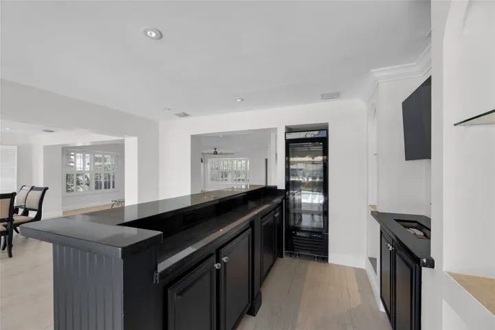 Fabulous wetbar with wine cooler and sink and tons of counter and storage space is perfect for entertaining