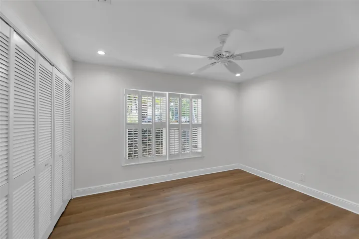 Guest bedroom offers great closet space and plantation shutters