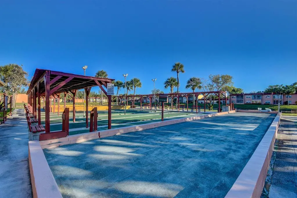 Multiple bocce ball courts with covered seating areas
