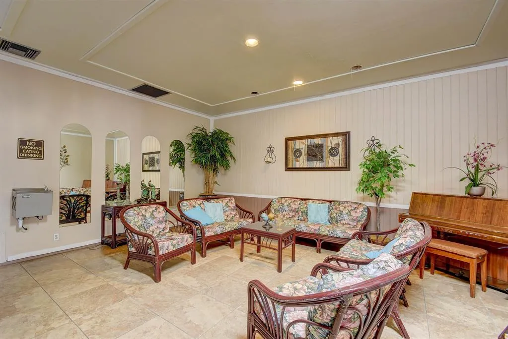 Recessed ceiling lighting, decorative ceiling molding, tile flooring, and wainscoting details