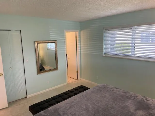 Light-colored wall paint and windows with horizontal blinds