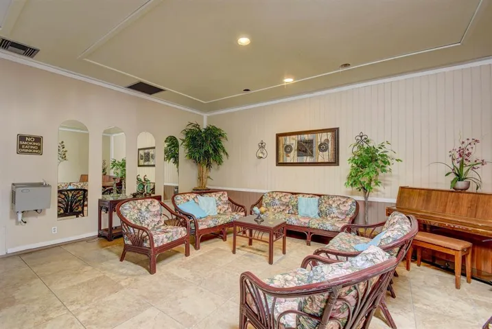 Recessed ceiling lighting, decorative ceiling molding, tile flooring, and wainscoting details