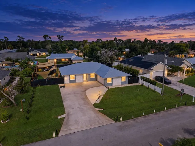 Contemporary exterior with a light-colored metal roof and a OVERSIZED concrete driveway AMPLE PARKING