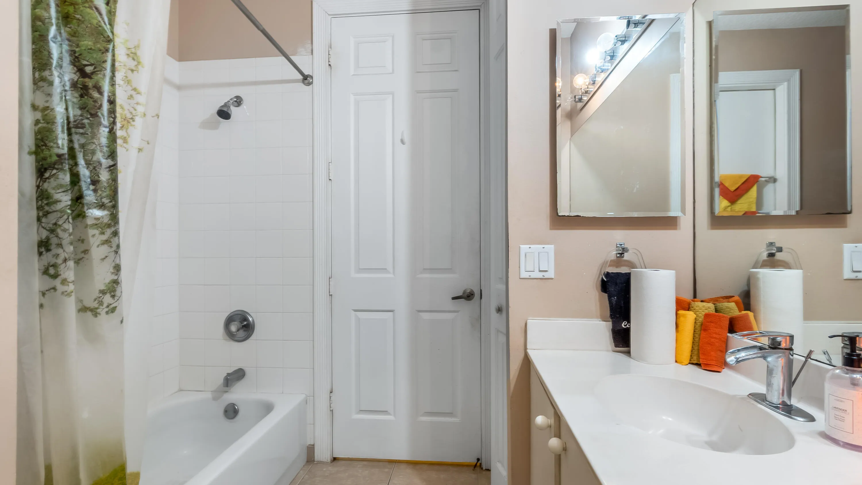 White tile shower surround with a tub/shower combination