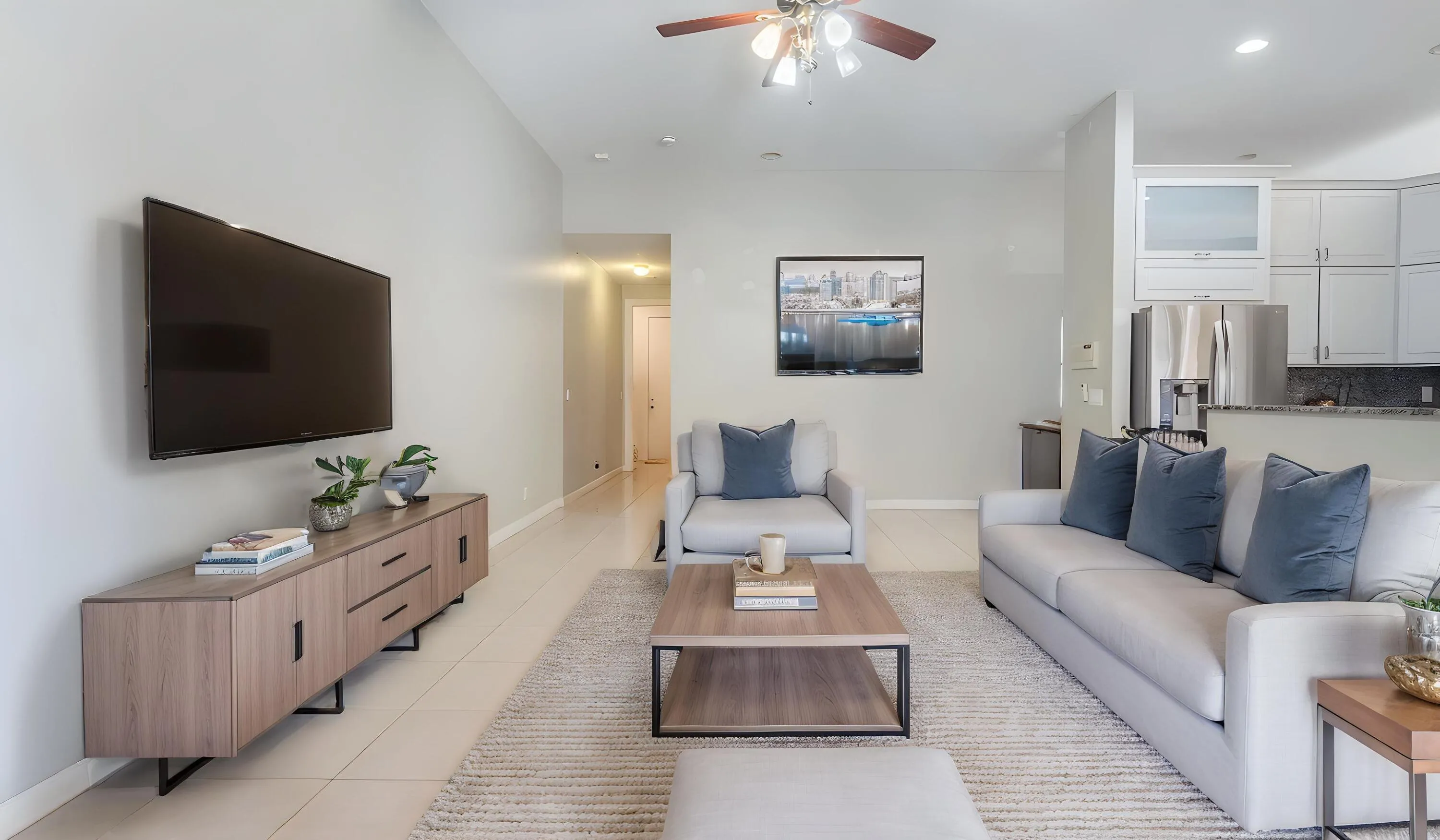 Vaulted ceilings, recessed lighting, tile flooring, ceiling fan, and built-in cabinetry