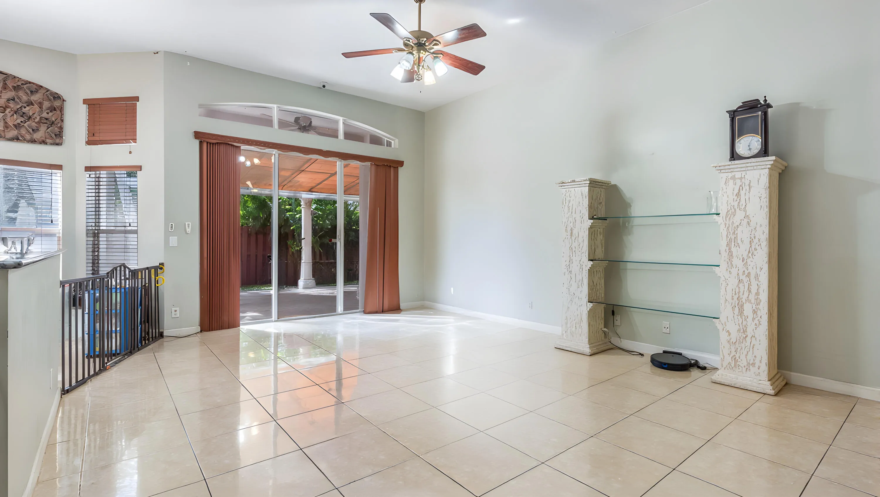 Spacious interior with tile flooring, vaulted ceiling, and ceiling fan