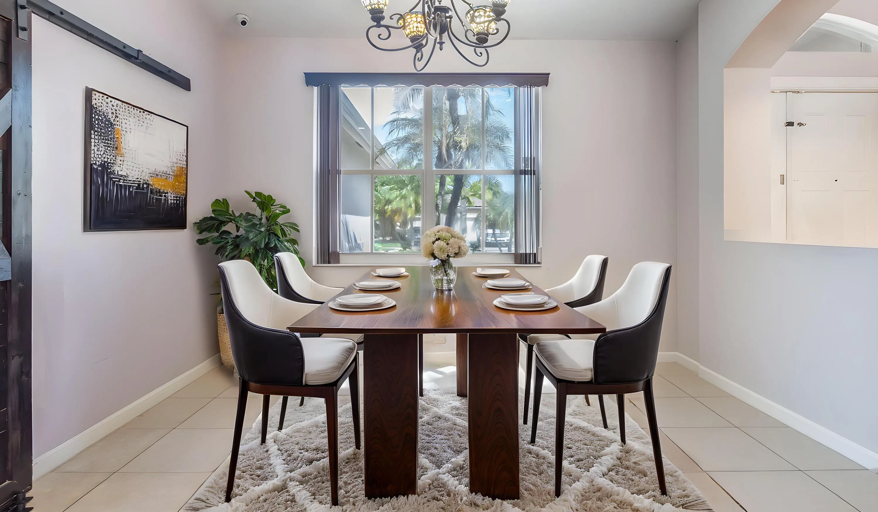 Recessed lighting with a decorative chandelier, a window with horizontal blinds, and tile flooring