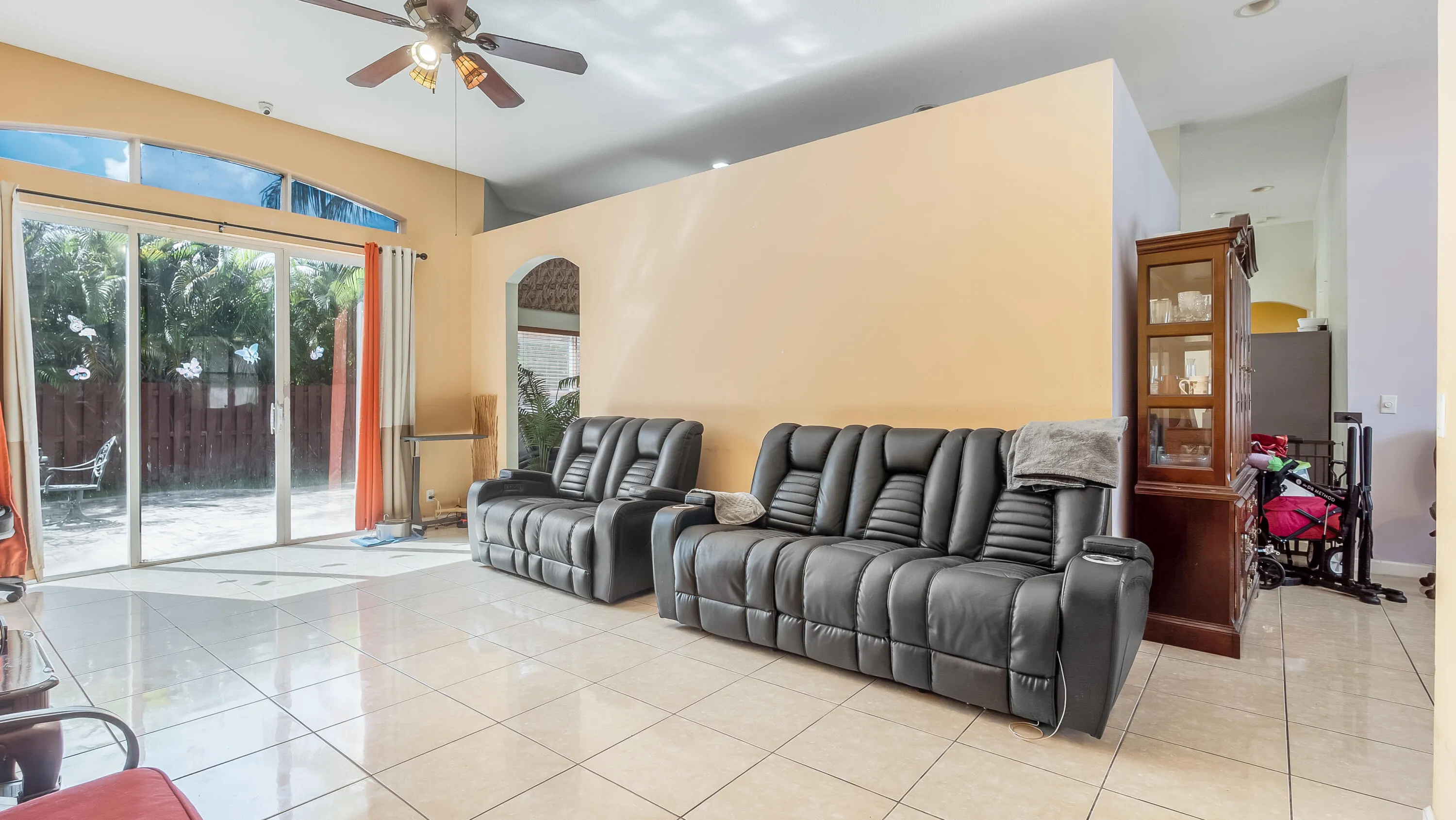 Tiled flooring throughout, vaulted ceilings, and a ceiling fan
