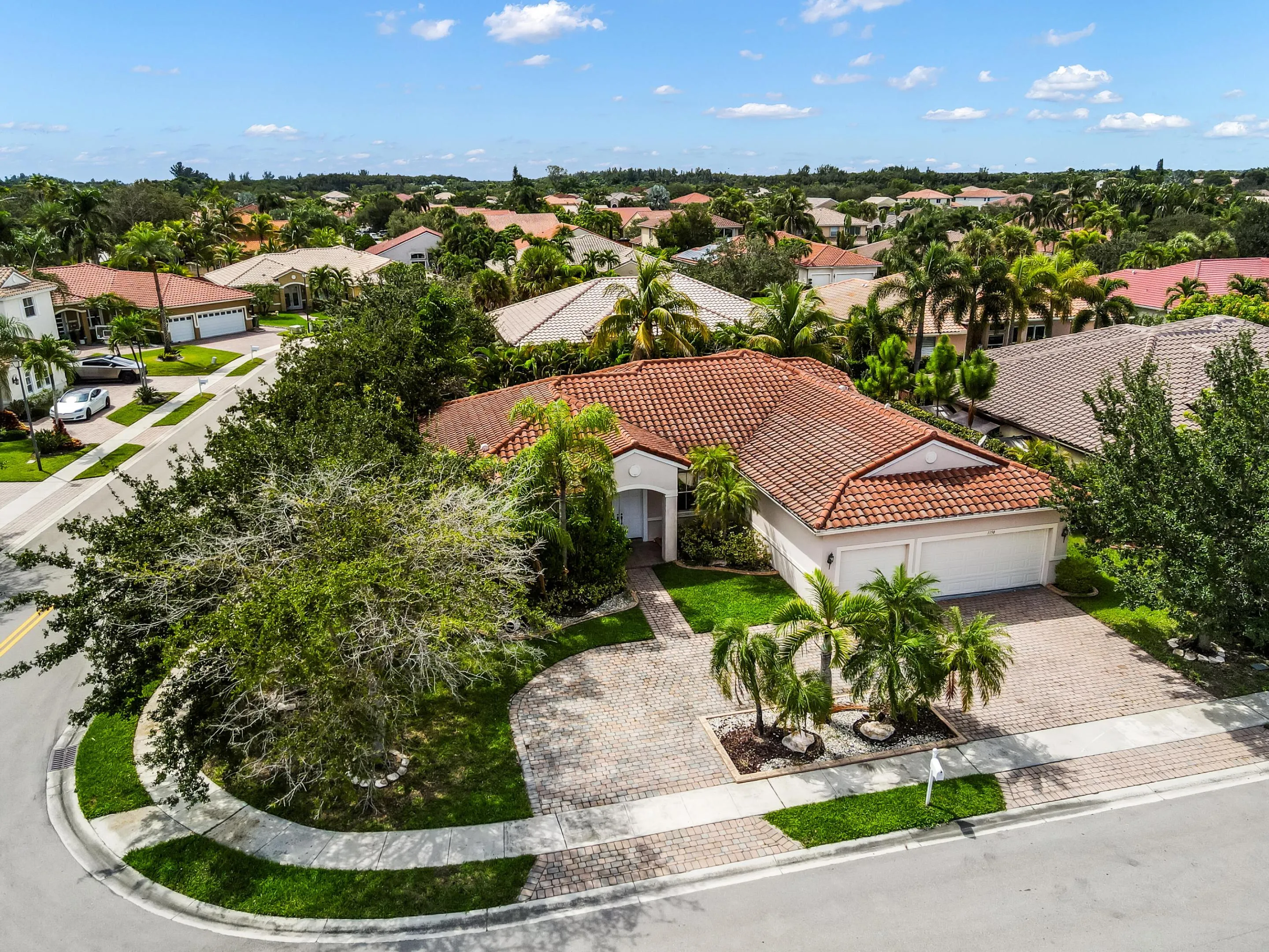 Single-story residence featuring a tile roof and a two-car garage