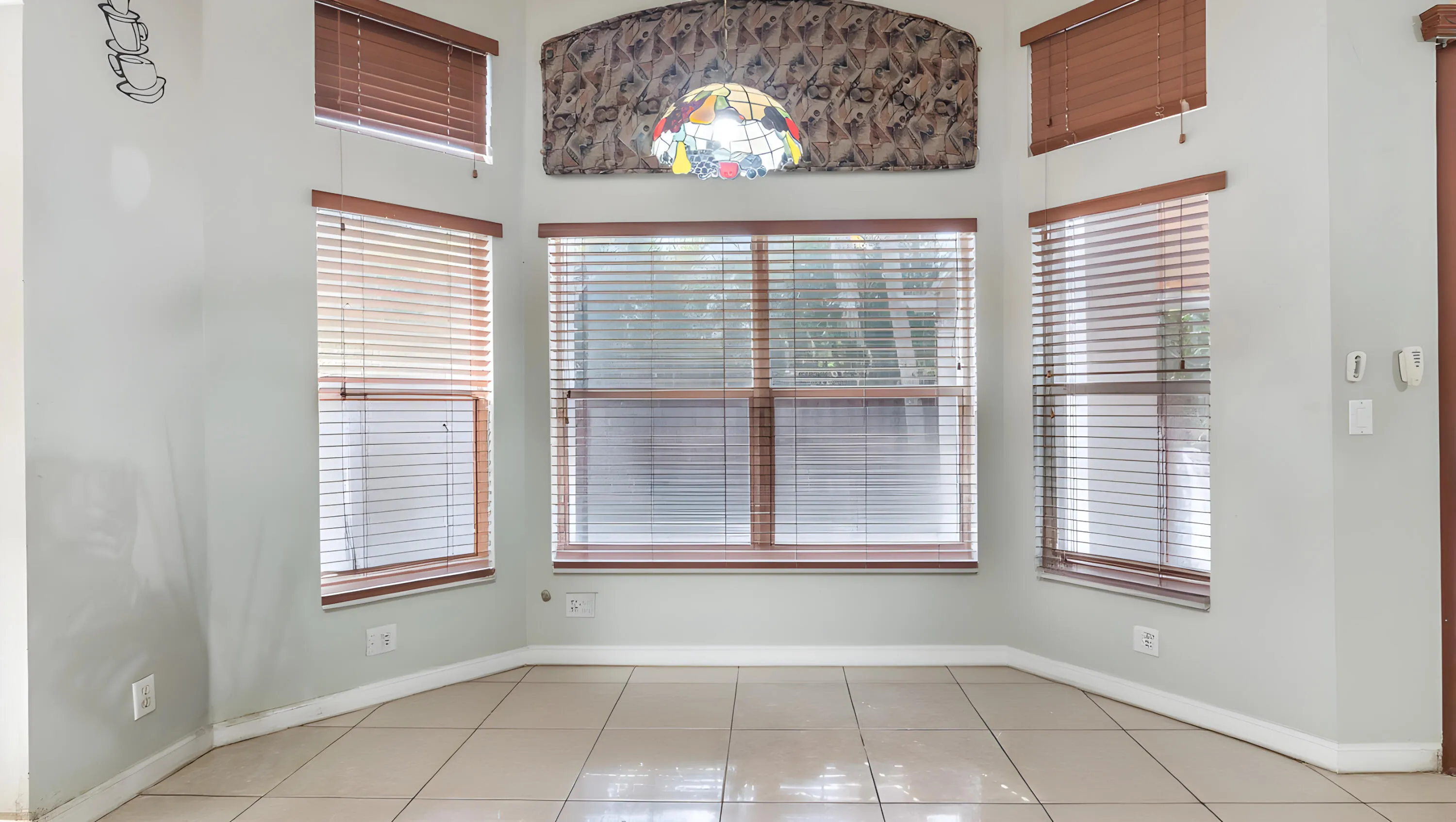 Bay window with multiple windows, arched transom window, and tile flooring