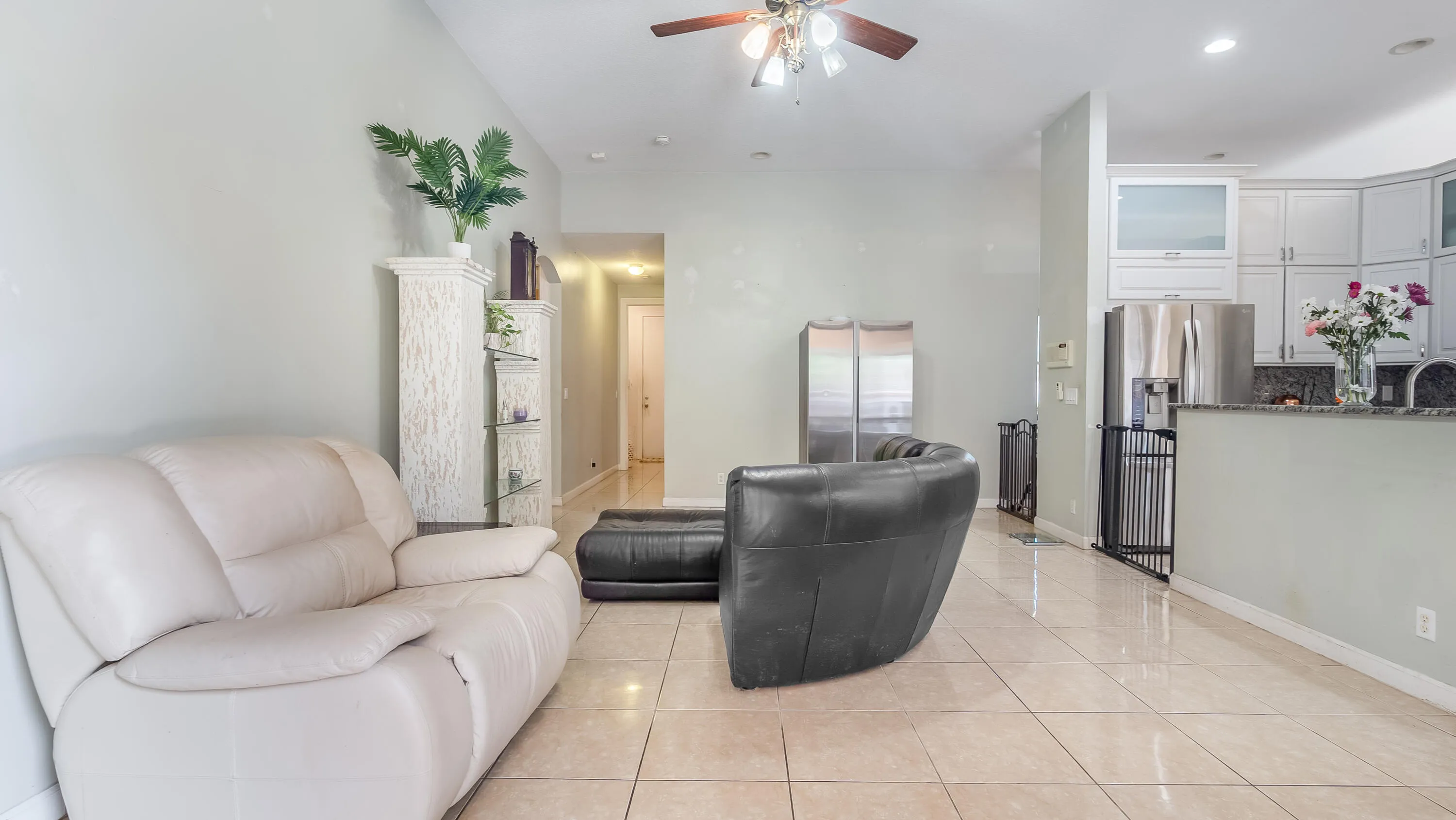 Tile flooring throughout, recessed lighting, ceiling fan, and white cabinetry