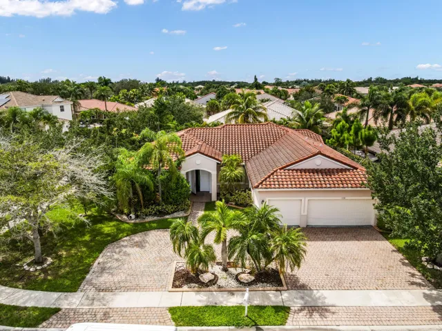 Tile roof, Three-car garage, mature landscaping, paved driveway, and covered entry