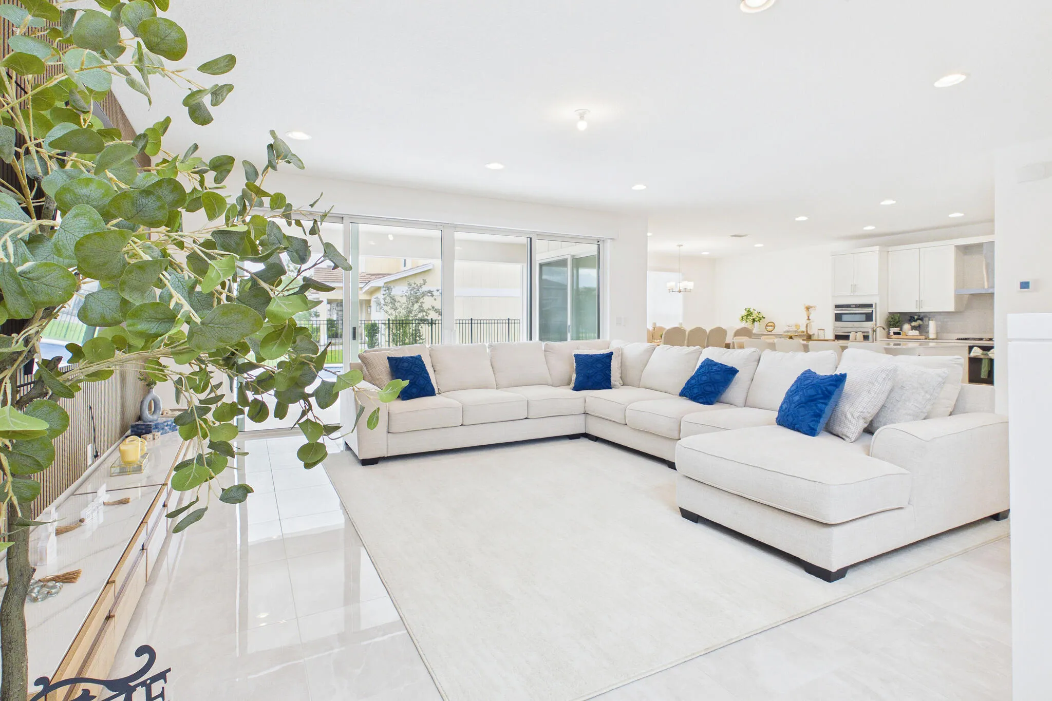 Open-concept living area with tile flooring and recessed lighting