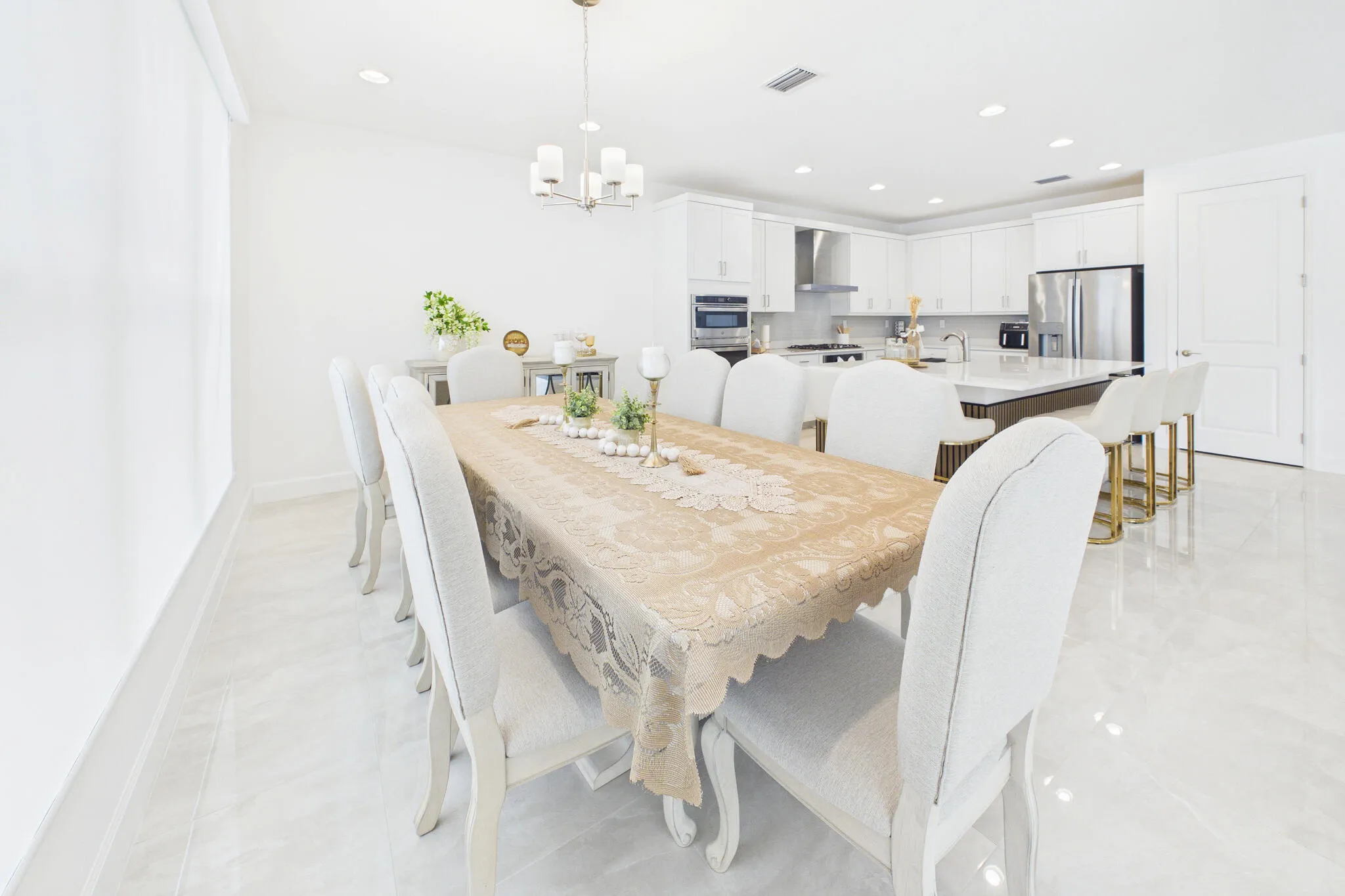 Open-concept dining area with large format tile flooring and recessed lighting