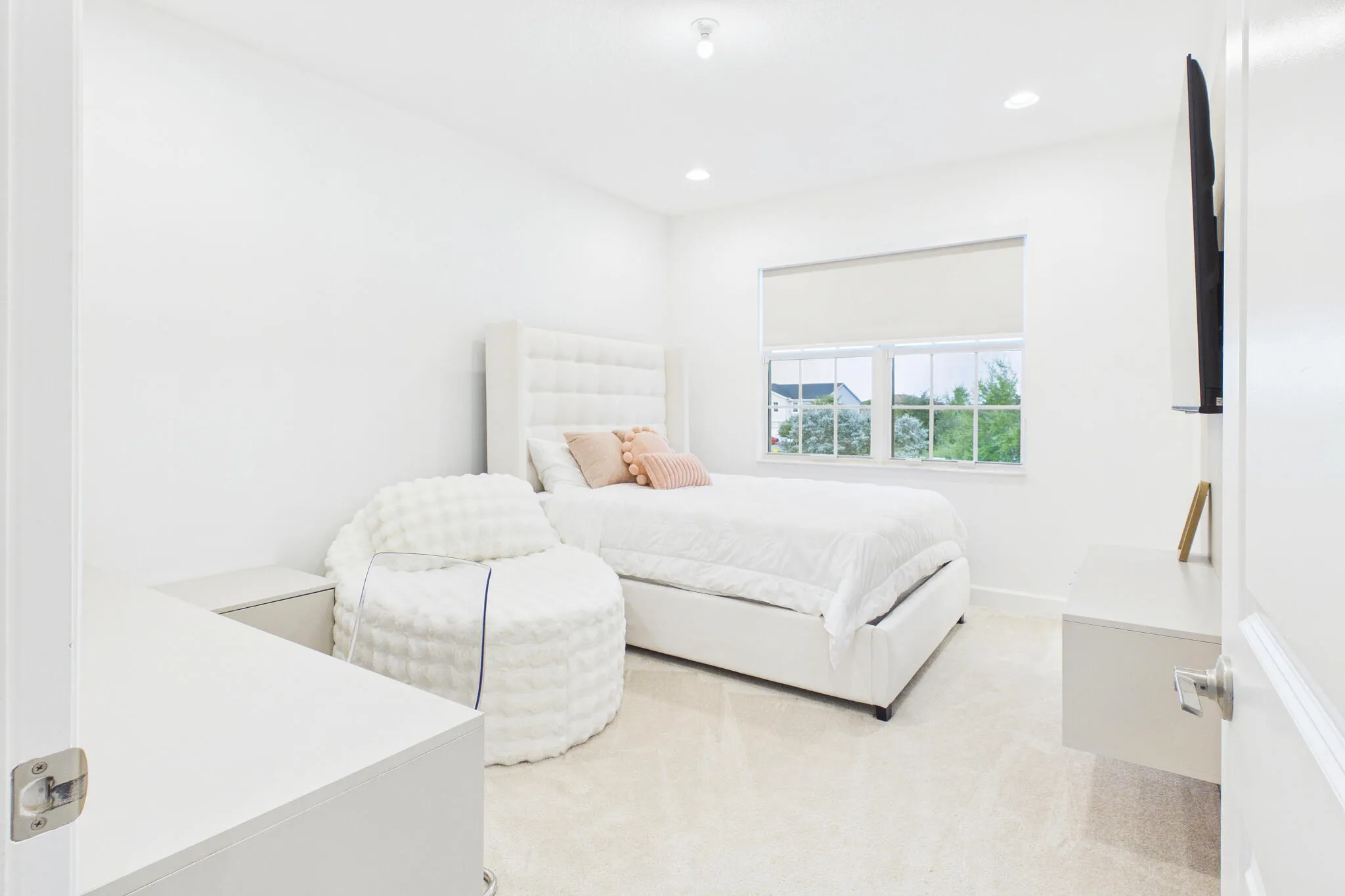 Recessed lighting, neutral wall tones, and carpeted flooring