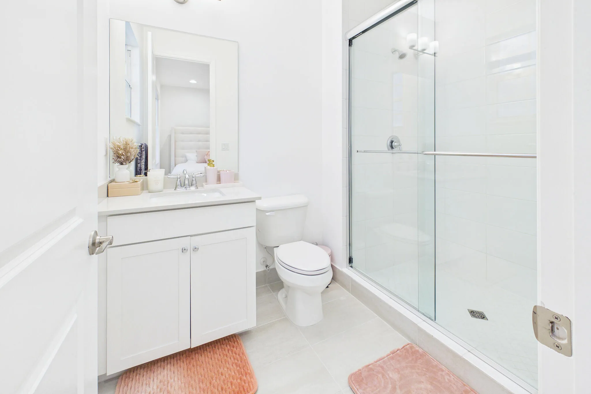 White vanity with a neutral countertop, undermount sink, and chrome faucet