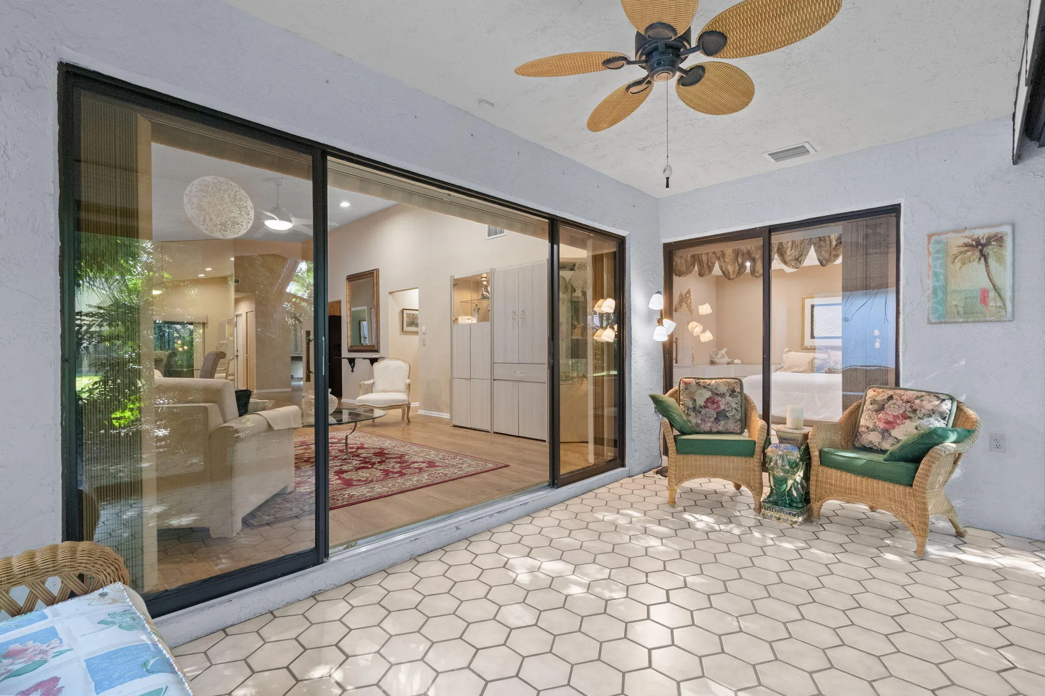 Outdoor patio with hexagonal tile flooring, equipped with a ceiling fan