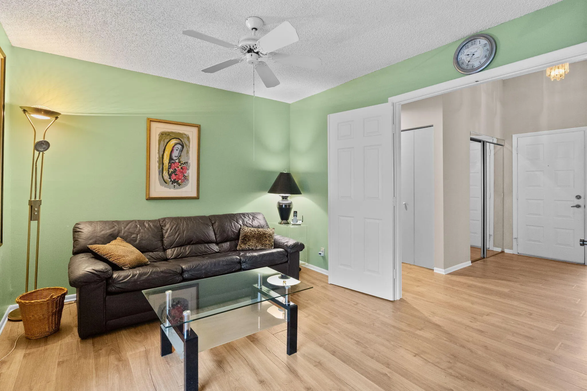 Wood-finish flooring throughout, complemented by a ceiling fan with integrated lighting