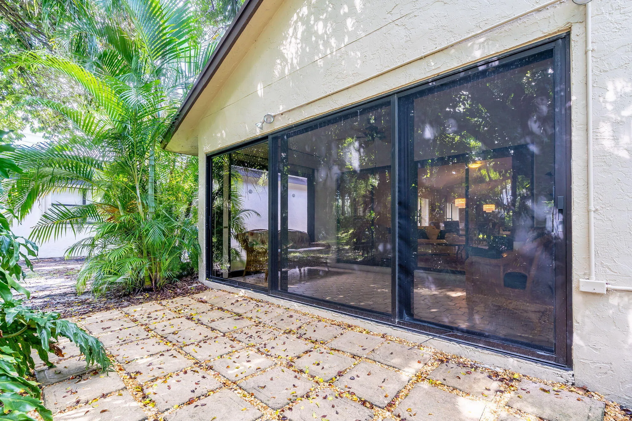 Expansive patio with stone pavers and mature landscaping