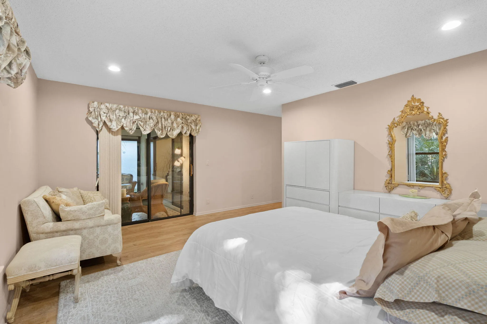 Sliding glass door leading to exterior, wood-finish flooring, recessed lighting, and a ceiling​​‌​​​​‌​​‌‌​‌‌​​​‌‌​‌​‌​‌​​​‌​​ fan