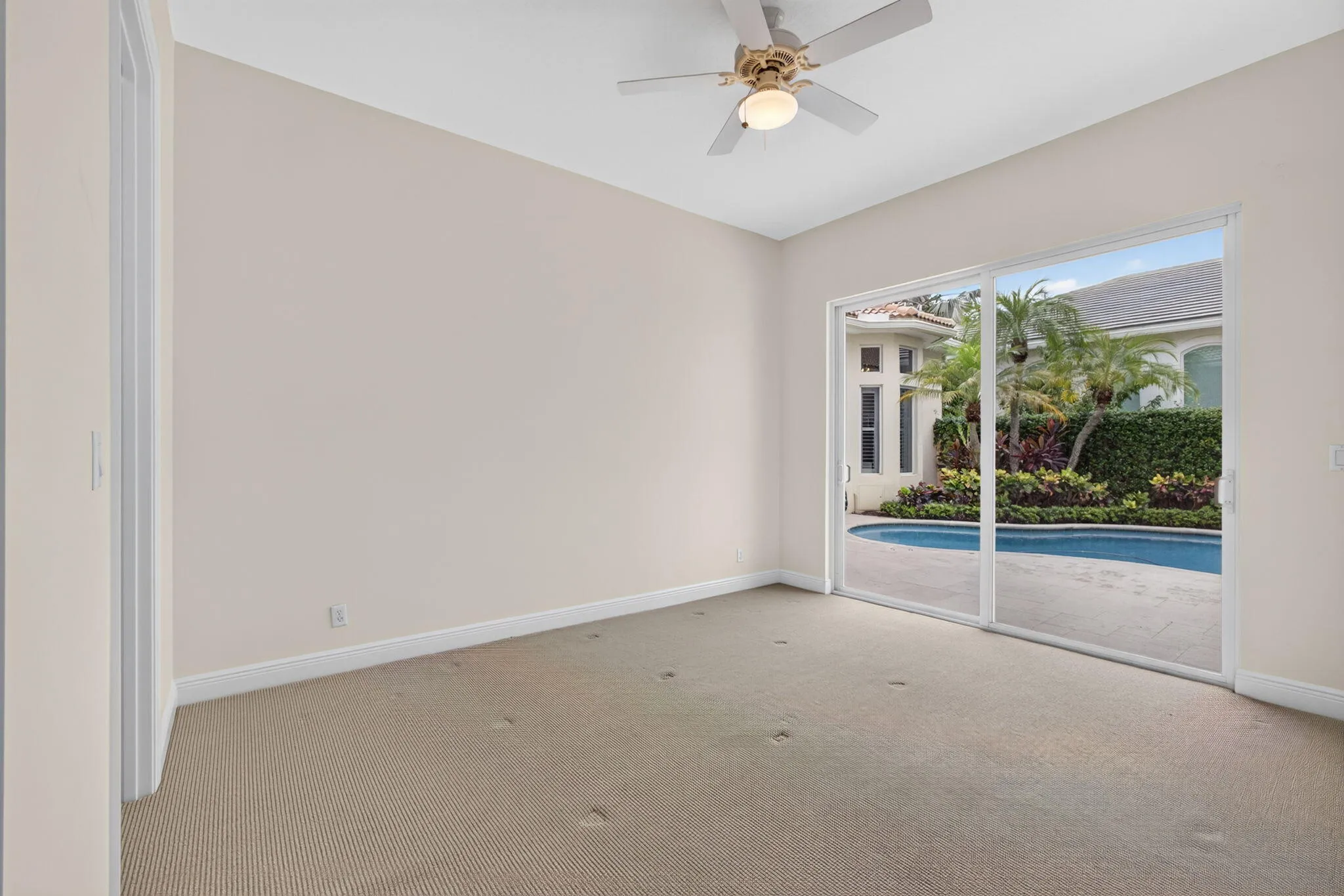 Large Bedroom with walk in closet and sliders to courtyard pool