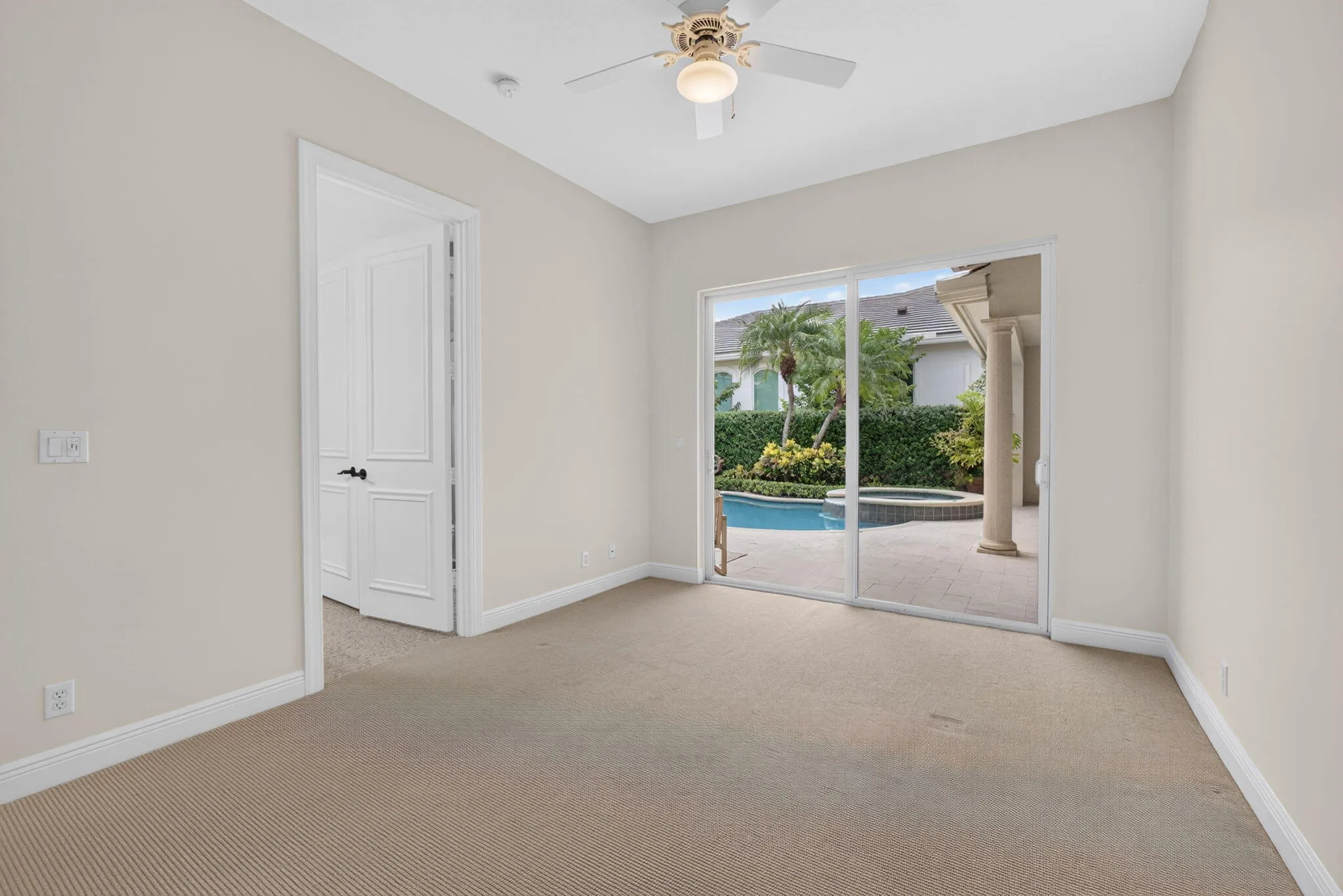 Large Bedroom with Walk In Closet and sliders to courtyard pool