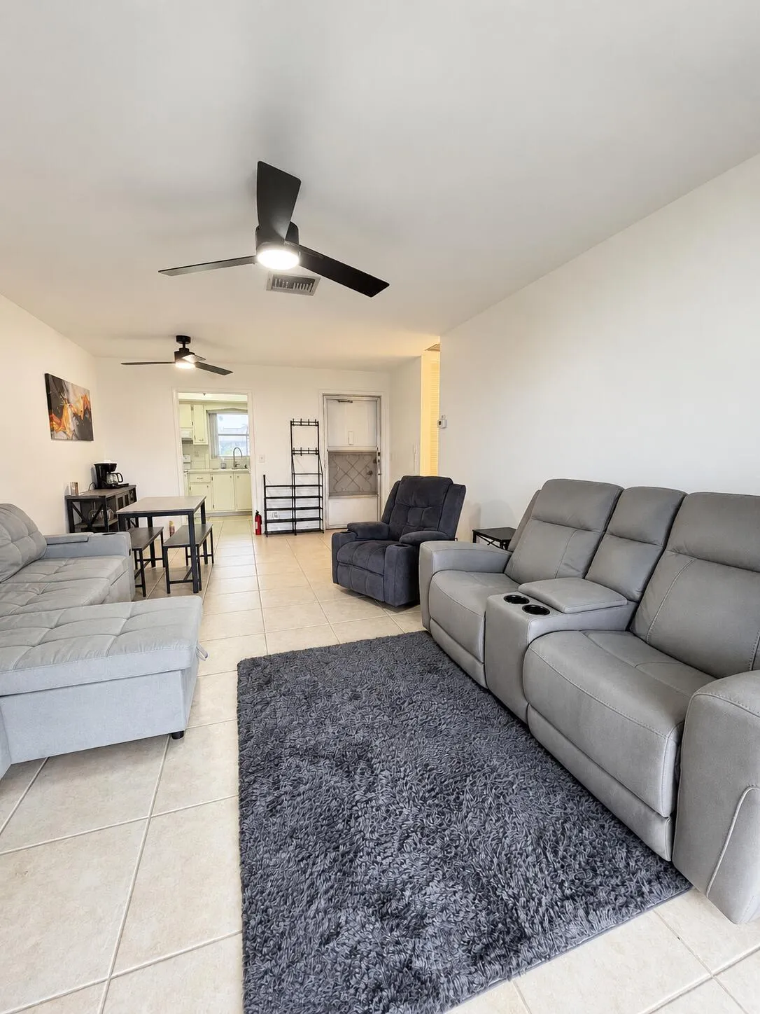 Living room facing front door and kitchen