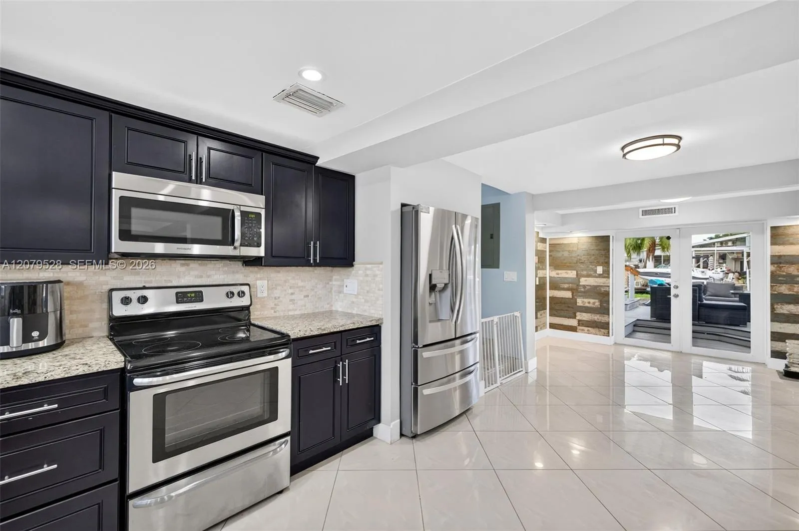 Open kitchen, beyond this space are french doors to pool deck
