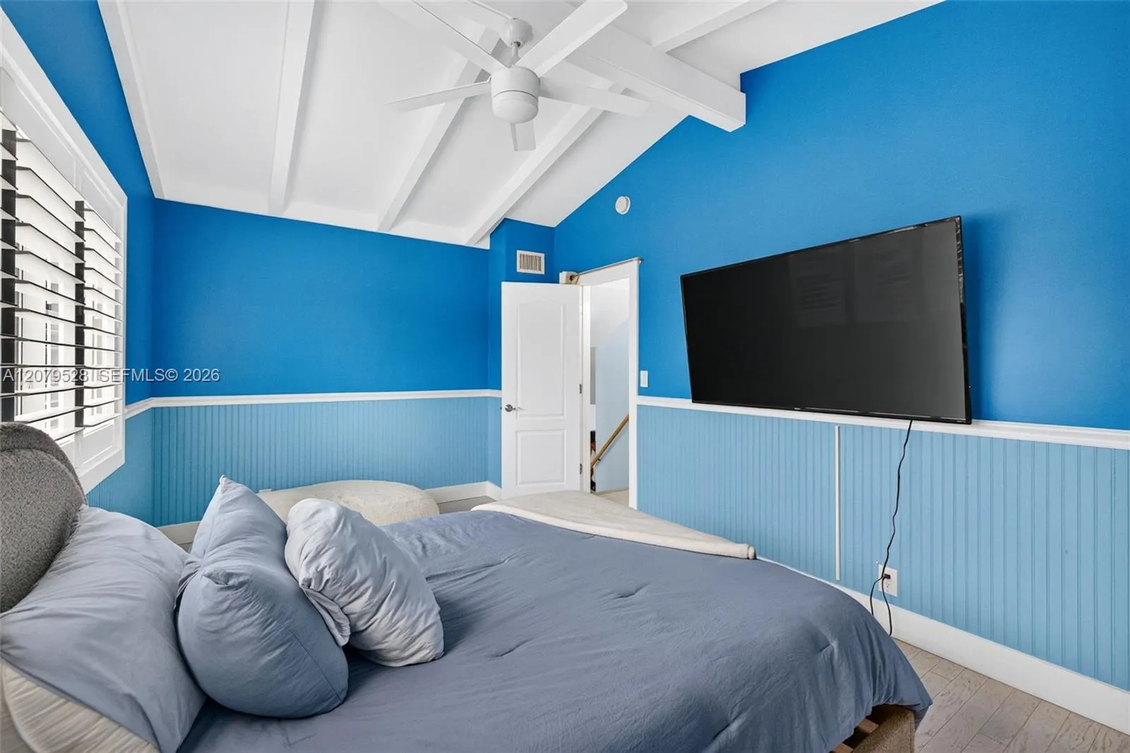Large guest bedroom upstairs w/ views to front of house, beamed ceiling
