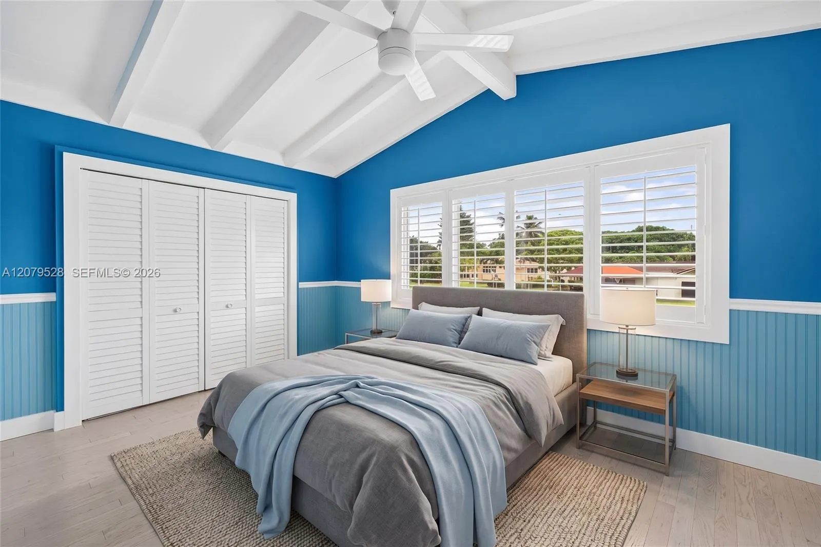 Large guest bedroom upstairs w/ views to front of house, beamed ceiling