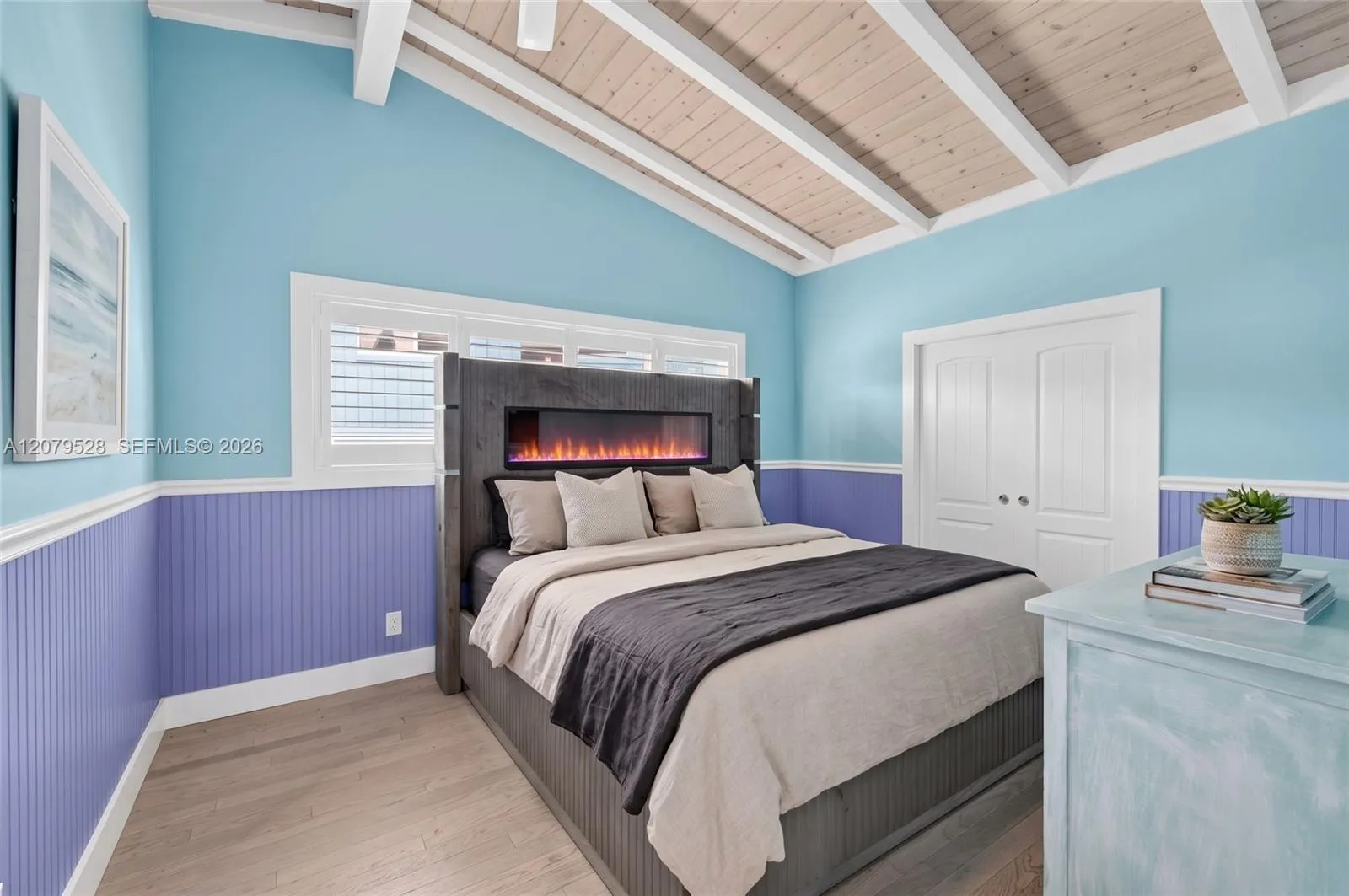 Oversized primary bedroom w/ beamed ceiling, Plantation Shutters and large walk in closet, en suite bathroom, on main level