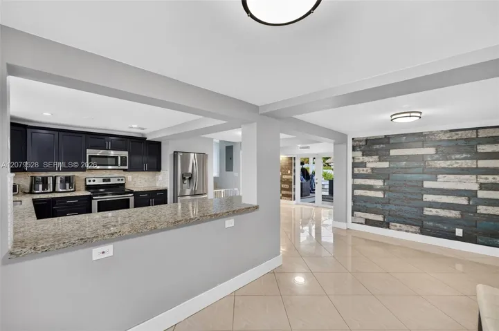 Open kitchen, beyond this space are french doors to pool deck