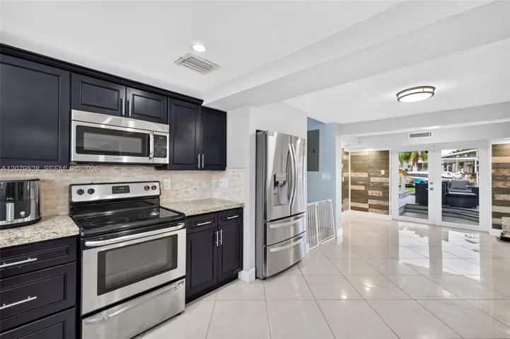 Open kitchen, beyond this space are french doors to pool deck