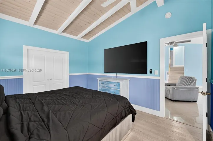 Oversized primary bedroom w/ beamed ceiling, Plantation Shutters and large walk in closet, en suite bathroom, on main level