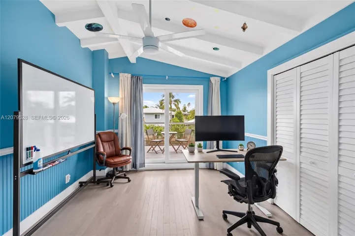 Guest bedroom w/ large private balcony w/ beamed ceiling overlooks pool area