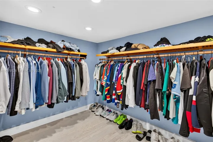 Oversized primary bedroom w/ beamed ceiling, Plantation Shutters and large walk in closet, en suite bathroom, on main level