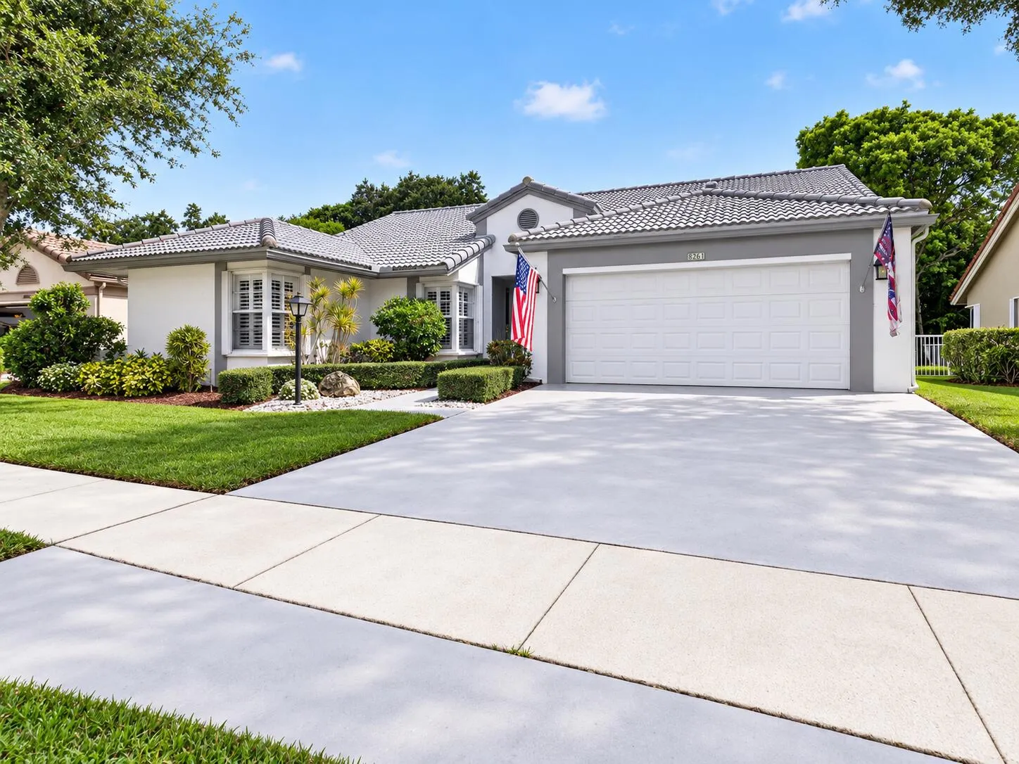 Front exterior with spacious driveway and two-car garage.
