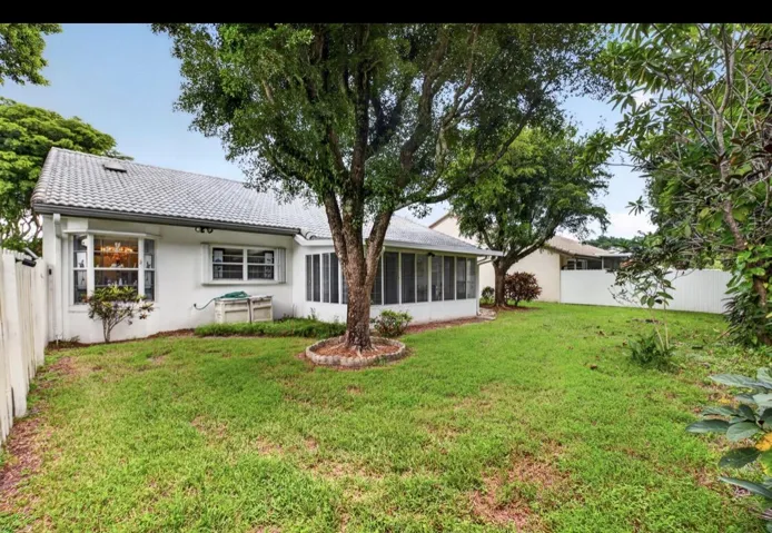 Generous backyard with mature shade trees and plenty of open space.