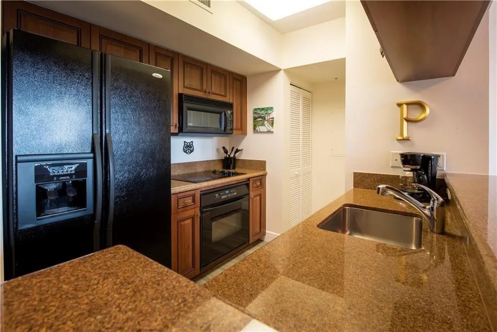 Galley kitchen with granite counter tops - Portelain floors throughout the living areas