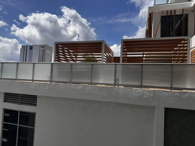 The view from the balcony looks into the amenity deck of the new building next door