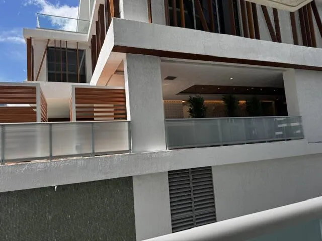 The view from the balcony looks into the pool deck of the building.
