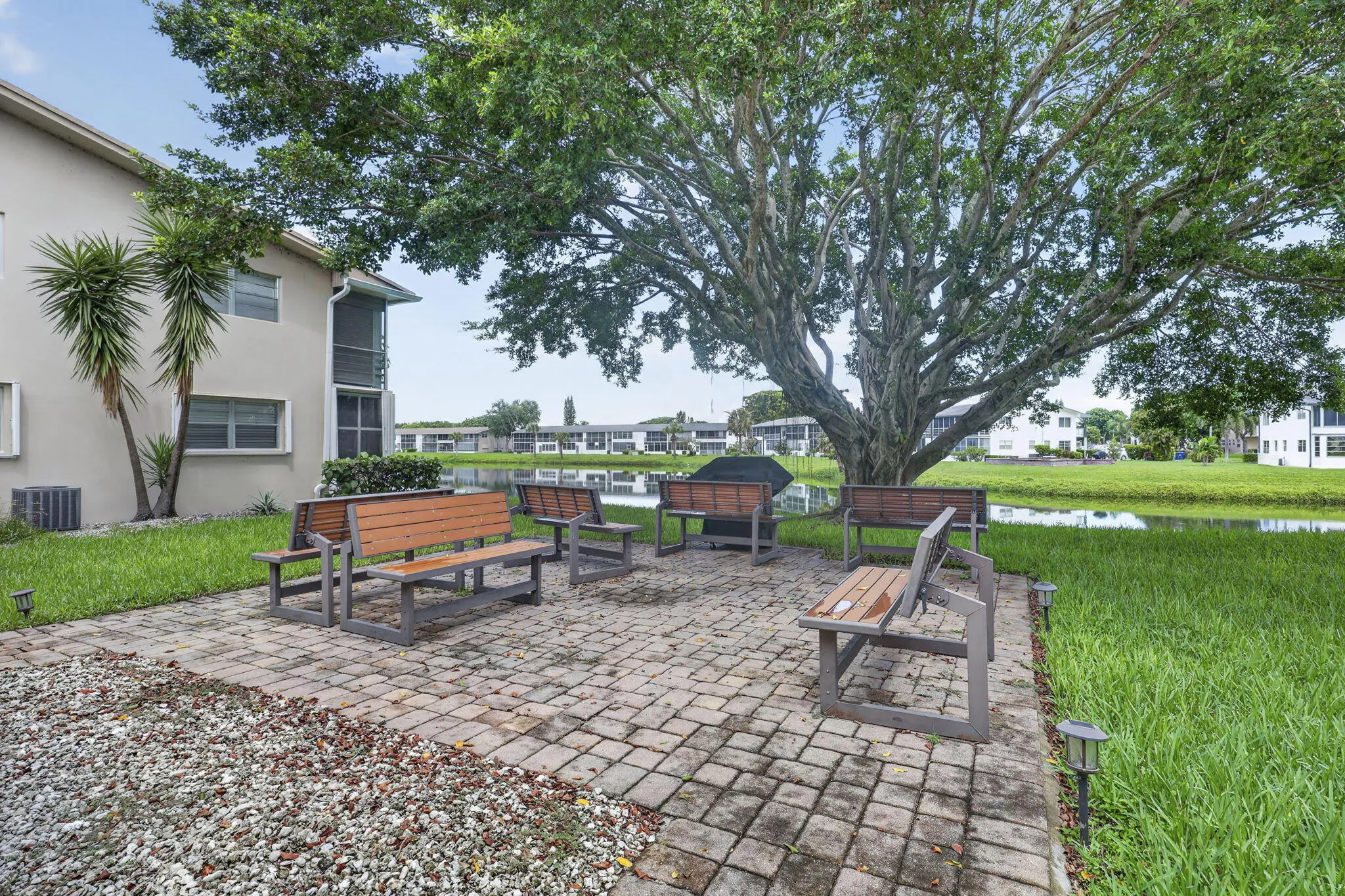 Paver patio surrounded by lush landscaping