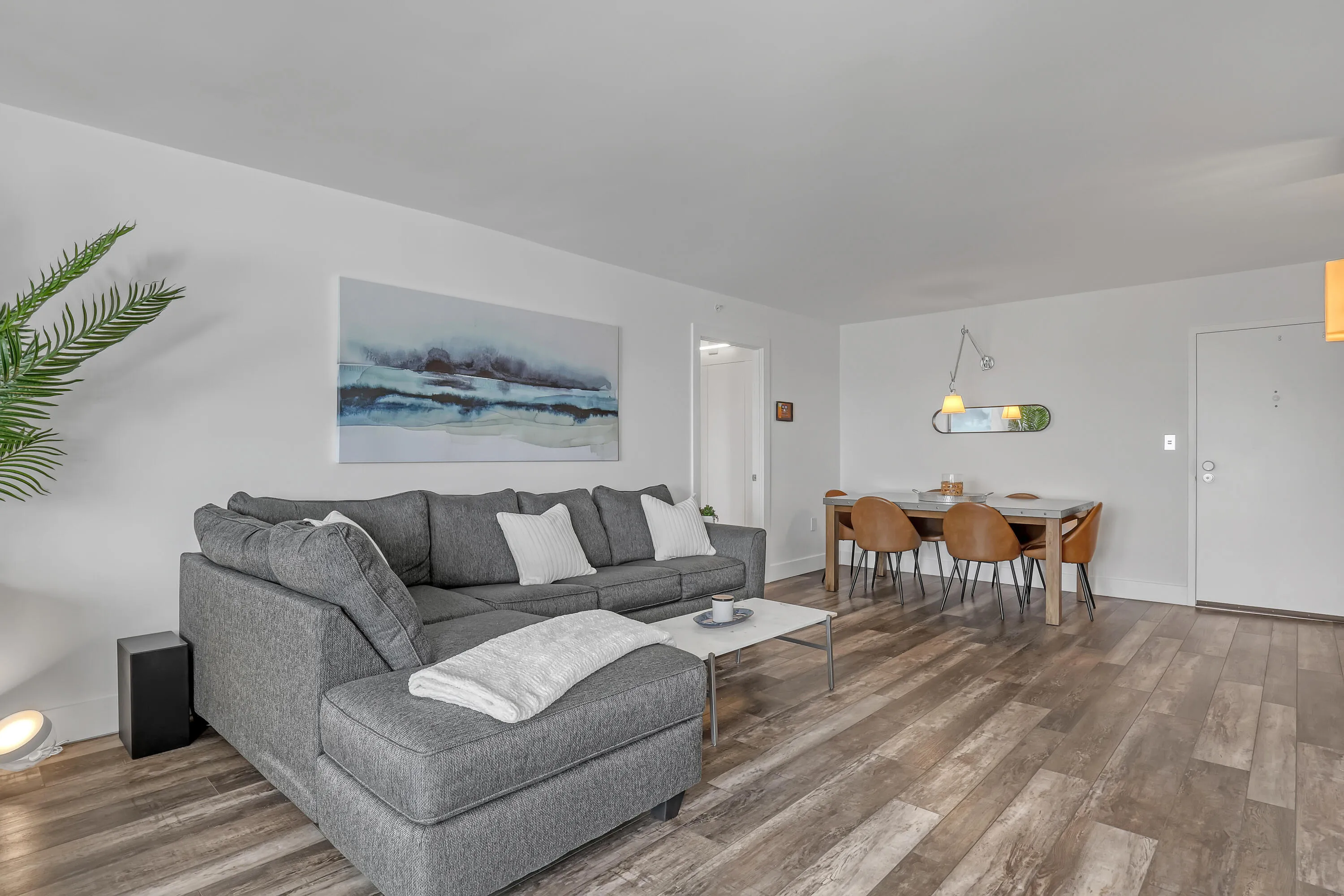 Open-concept living space with wood-finish flooring